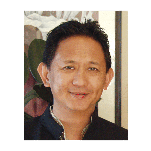 Photograph of a youthful Dzigar Kongtrul Rinpoche in traditional wear