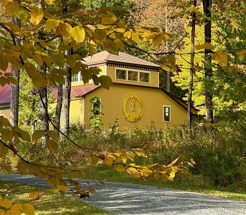 the MSB logo on the side of Pema Osel Do Ngak Choling in the fall