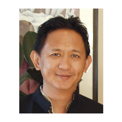 Photograph of a youthful Dzigar Kongtrul Rinpoche in traditional wear